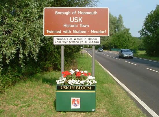 "Usk in Bloom" sign